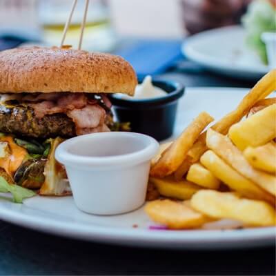 close up of a plate with a burger and fries on it