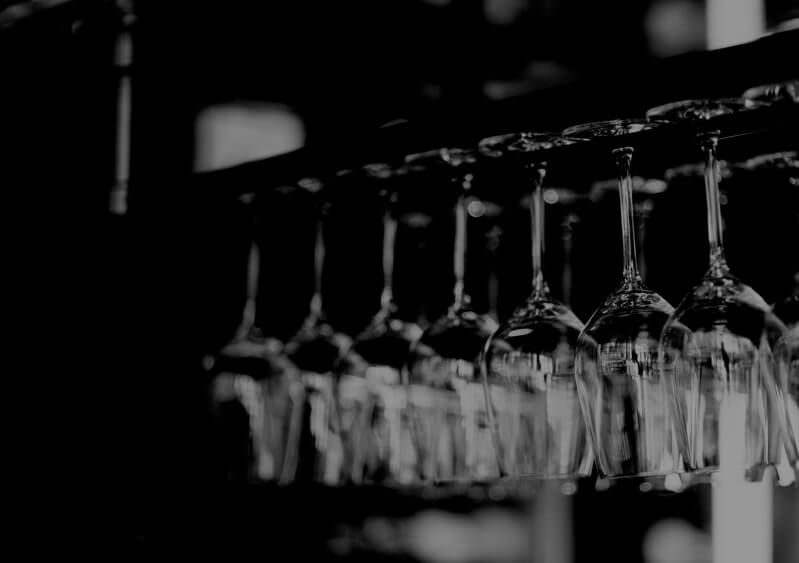 row wine glasses hanging upside down by bottoms