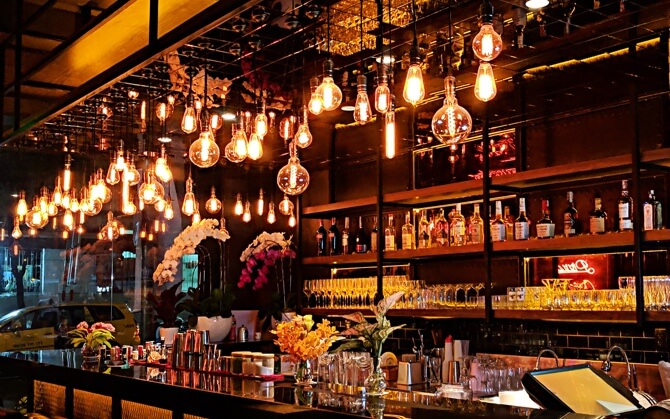 image of bar with edison light bulbs hanging from the ceiling